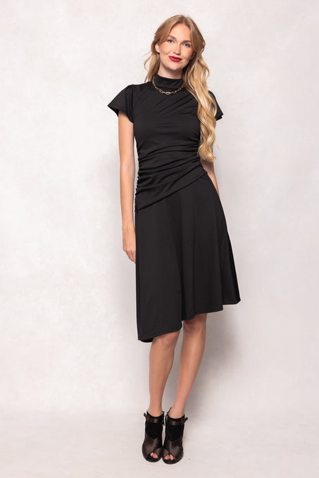 Woman wearing a black dress against a white background