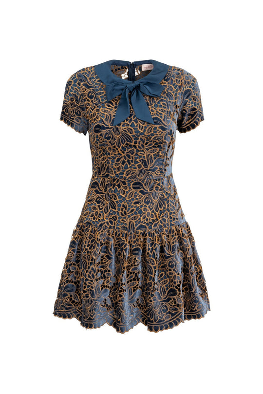 Patterned dress with a blue bow on a white background