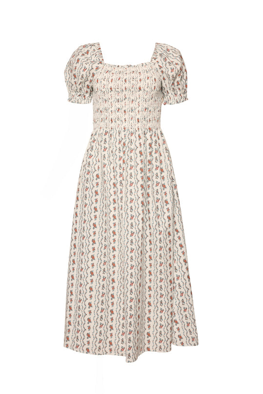 The Sunday Best Dress in Linear Poppy Woodblock by Ivy City Co is a white, short-sleeved maternity midi dress with a smocked bodice, puff sleeves, and delicate red and blue floral wavy stripes.