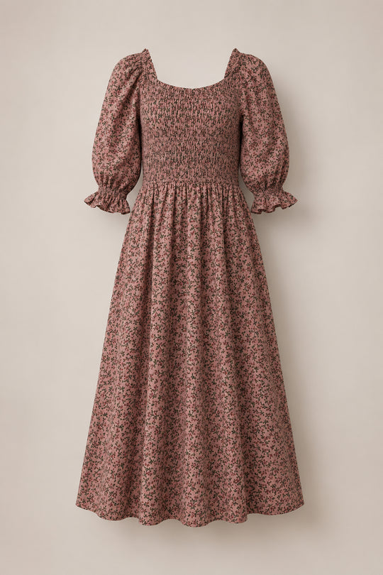 Introducing the Teagan Dress in Mauve Woodland Floral by Ivy City Co—a vintage-inspired midi dress featuring puff sleeves, a smocked bodice, and a delicate mauve woodland floral pattern on a maroon background. Displayed against a neutral backdrop, this maternity-friendly piece offers effortless elegance, making it perfect for any occasion.