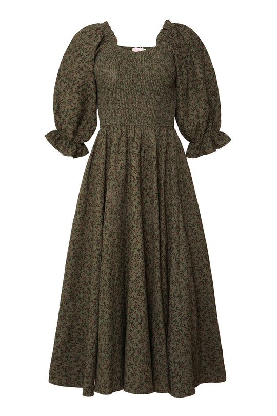 The Teagan Dress in Woodland Floral by Ivy City Co features a long olive green floral print, puffed half sleeves with ruffled cuffs, a smocked bodice, and full ankle-length skirt. Maternity and nursing friendly for versatile comfort.