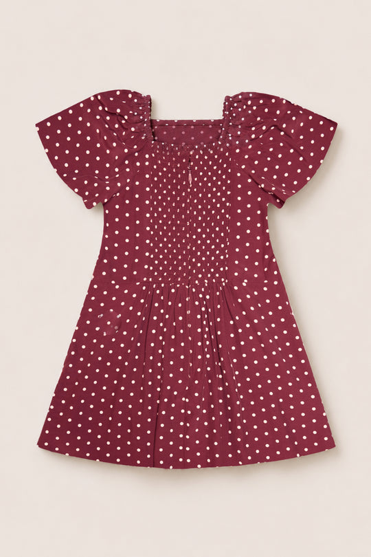 The Ivy City Co Teen Blakely Dress in Cranberry Dainty Dot features a flattering midi-length silhouette with a square neckline, puffed short sleeves, white polka dots, and gathered details on the chest and skirt.