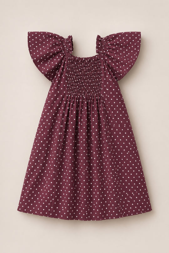 Teen Blakely Dress in Aubergine Ditsy Dot by Ivy City Co, featuring a smocked bodice and large flutter sleeves, displayed flat on a neutral background.