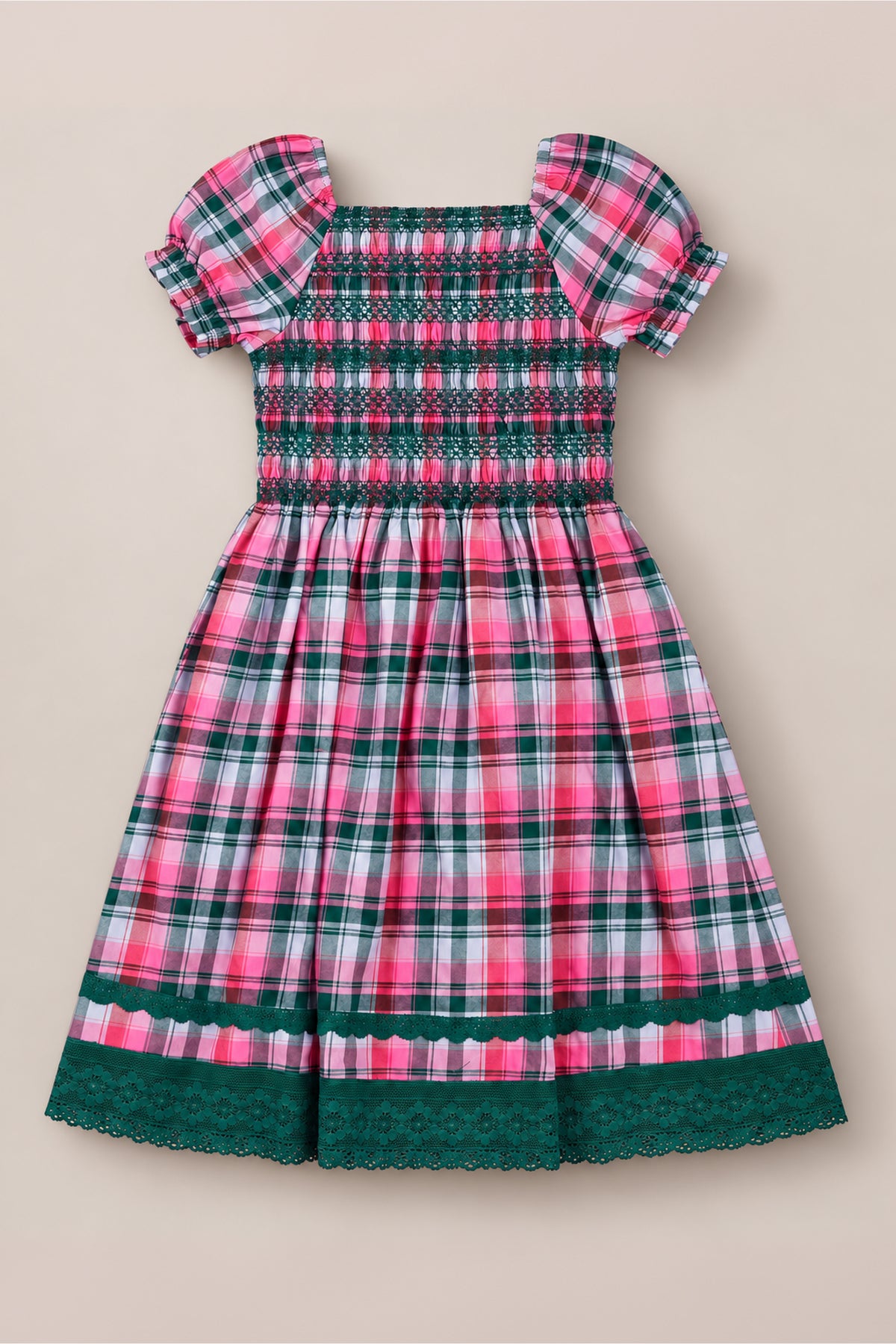 The Ivy City Co Teen Sunday Best Dress in Vibrant Plaid features a charming pink, green, and white plaid pattern, a smocked bodice, puff sleeves, and delicate green lace trim at the sleeves and hem—making it the perfect festive Christmas dress or a delightful smocked cotton dress for any special occasion.