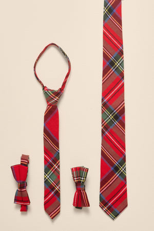 Red plaid tie and bow ties on a beige background
