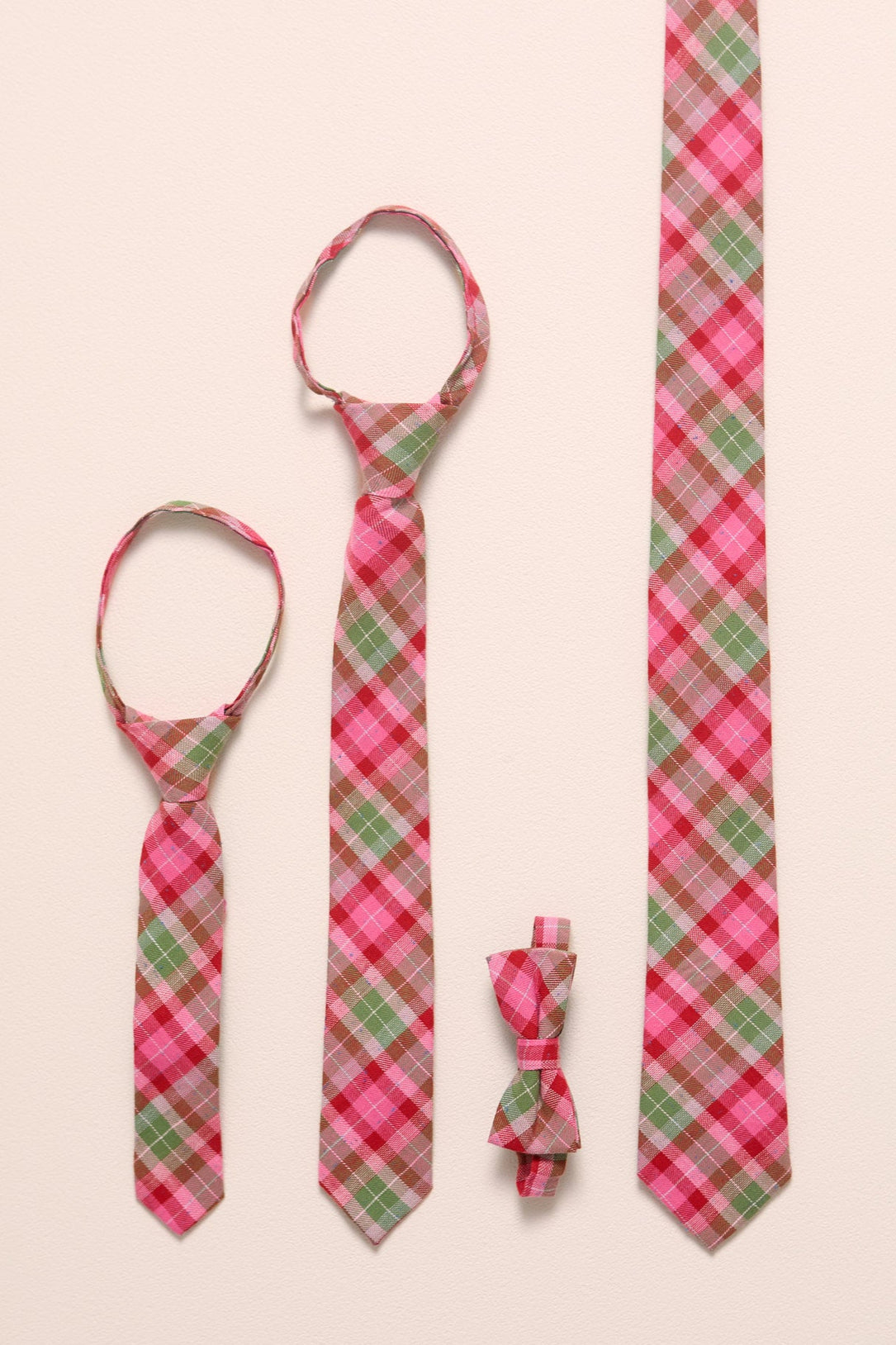 Set of plaid ties and a bow tie on a beige background