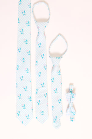 an assortment of blue floral ties laying flat against a white backdrop