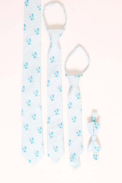 an assortment of blue floral ties laying flat against a white backdrop
