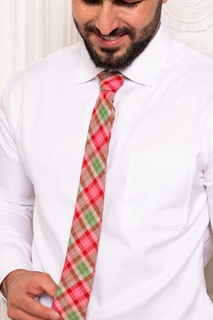 Man wearing a white shirt and a red and green plaid tie.