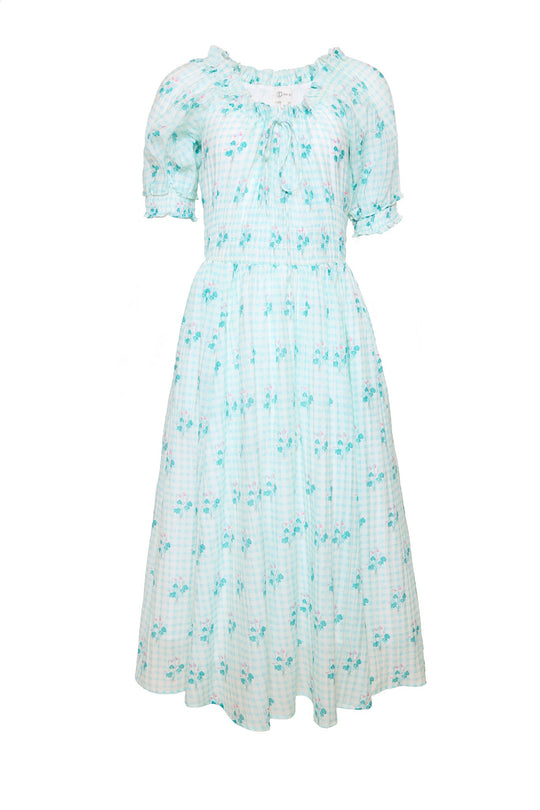 The Jessie Dress in Bloom Gingham by Ivy City Co is a light blue and white gingham midi dress with short sleeves, a ruffled neckline, and a delicate floral pattern throughout. This charming dress features a fitted waist, flowy skirt, and is designed to be both nursing friendly and maternity friendly, offering effortless style at every stage.