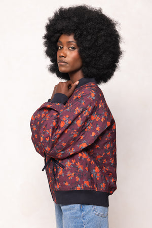 Person wearing a patterned jacket with a plain background
