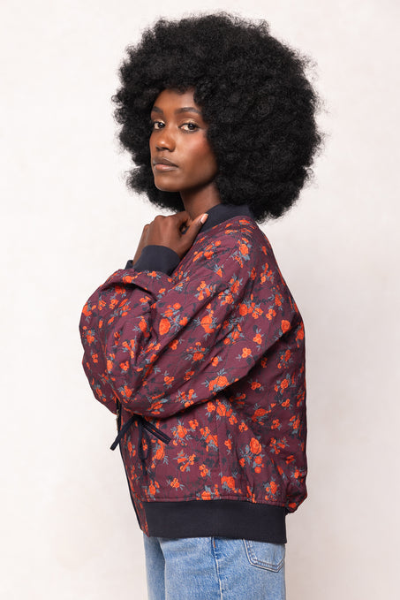 Person wearing a patterned jacket with a plain background