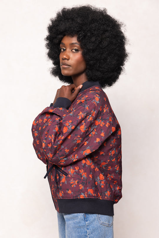 Person wearing a patterned jacket with a plain background