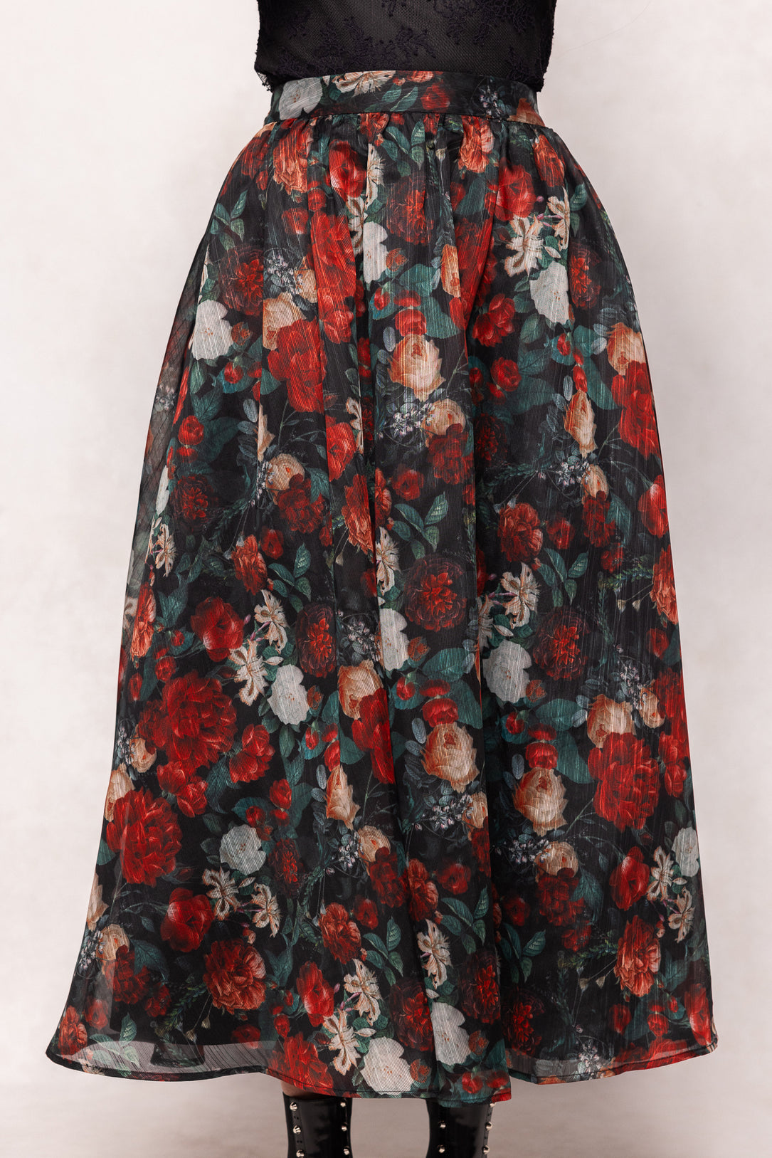 Floral patterned skirt with red, black, and white colors on a white background