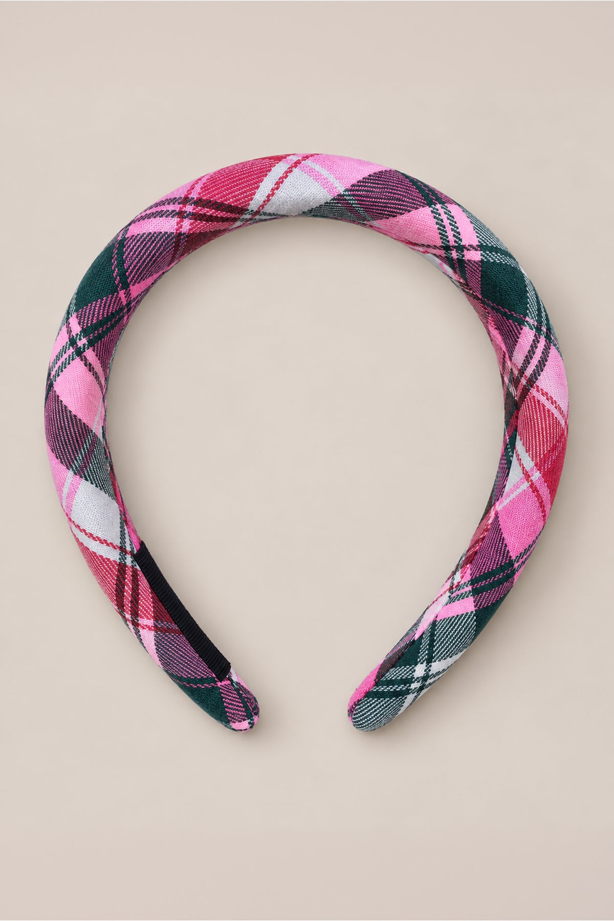 The Ivy City Co Hair Bows in Vibrant Plaid feature a soft, padded headband wrapped in pink, red, black, and white plaid fabric—displayed on a light beige background for the perfect holiday accessory that brings festive flair to any look.
