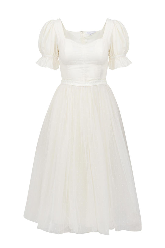 The Ballerina Dress in White by Ivy City Co. features puffed short sleeves, a fitted bodice, a flared tulle skirt, and a square neckline with subtle dotted details for an elegant, graceful look.
