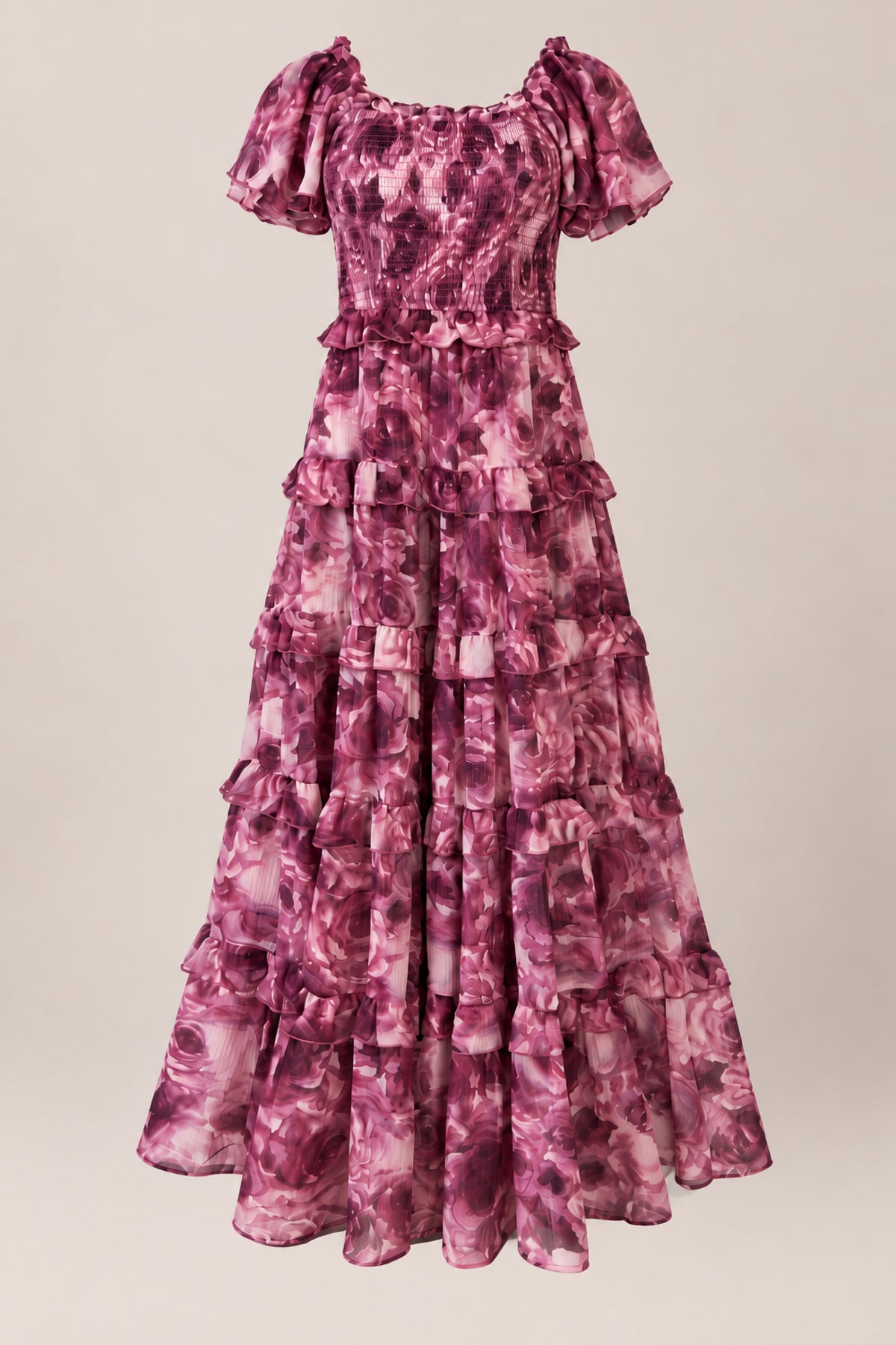 The Winnie Dress in Dreamy Roses by Ivy City Co is a long, ruffled chiffon girls’ dress featuring short sleeves, a fitted bodice, and a tiered skirt. Showcasing a mauve and pink floral pattern accented with a subtle gold metallic stripe, this charming holiday dress is displayed against a neutral background.