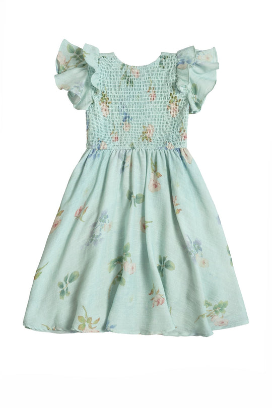 The Mini Hattie Dress in Roselyn Blue by Ivy City Co is a light blue cotton-linen dress for young girls, featuring ruffled short sleeves, a smocked bodice, and a flared skirt adorned with delicate pink and green floral patterns. Perfect as a girls’ party dress or for any special occasion, this charming piece beautifully combines comfort and style.
