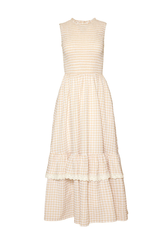 The Presley Sleeveless Dress in Cream Gingham by Ivy City Co features a beige and white checkered pattern, a comfortable smocked bodice, ruffled skirt with lace trim, and a round neckline—crafted in a maternity-friendly design for ultimate comfort and style.
