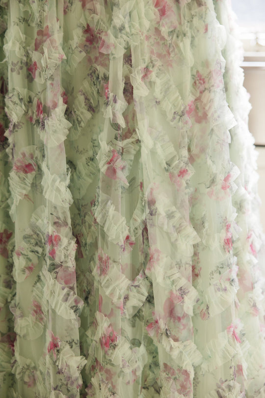 Close-up of light, sheer fabric with a ruffled texture and a pastel floral print in shades of pink, green, and white—perfect for the Ivy City Co Florentina Dress in Pistachio Aquarelle Fleur, a nursing-friendly style that is effortlessly chic.