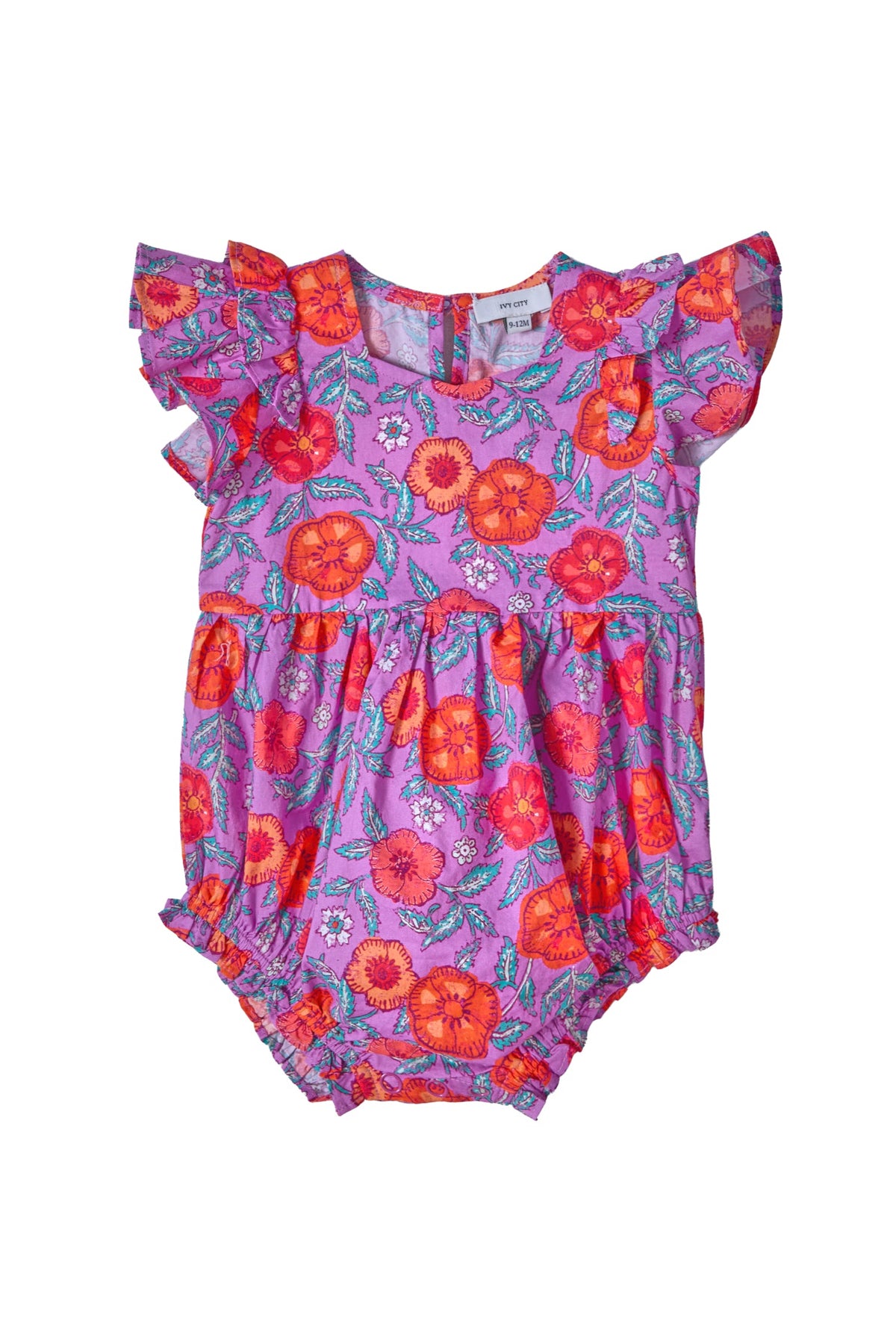 The Baby Hattie Romper in Thistle Flower Poppy Woodblock by Ivy City Co is a pink cotton baby romper with ruffled sleeves, adorned with a lively red and orange floral print and green leaves—perfect for little ones who adore cheerful colors.