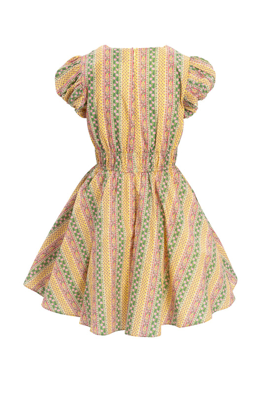 The Zaza Dress by Ivy City Co is a short-sleeved, knee-length tulle dress with a gathered waist and puffed sleeves, featuring colorful vertical stripes in yellow, green, pink, and orange, made with Liberty Fabric.