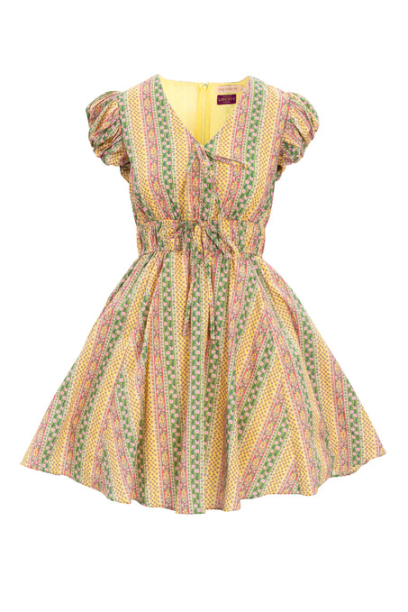 The Zaza Dress Made With Liberty Fabric by Ivy City Co is a short-sleeve, knee-length tulle dress with a flared skirt and drawstring waist, featuring vibrant multicolored stripes, floral and geometric folk-inspired patterns.