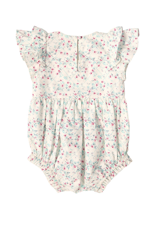 Introducing the Baby Hattie Romper in Pansy Trellis by Ivy City Co. This charming romper showcases ruffled sleeves and a beautiful pastel floral pattern in pink and blue, inspired by the delicate Pansy Trellis design. With gathered elastic at the leg openings and an easy button closure at the back, it’s perfect for your little one’s first spring adventures or as an adorable addition to a Mom & Me Easter set.