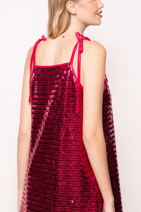 Red sequin dress with thin straps on a plain background