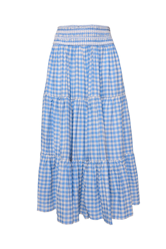 The Zoey Skirt in Blue Gingham by Ivy City Co features a smocked waistband, tiered design with gathered seams for a ruffled effect, and a flowy knee-length silhouette.