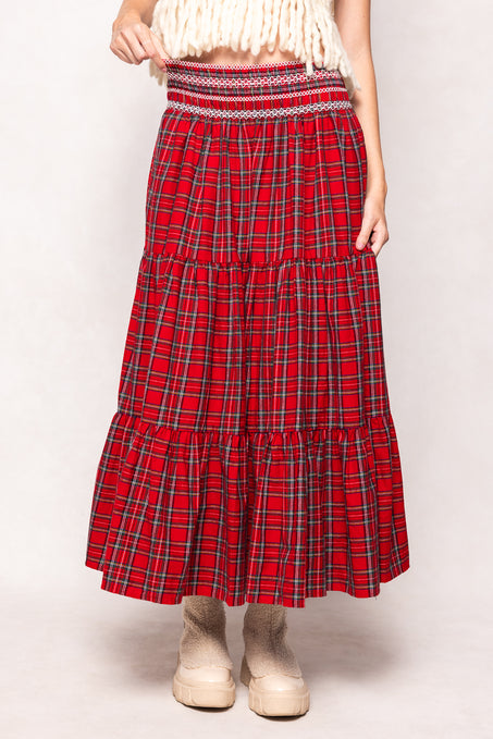 Red plaid skirt worn by a person on a white background