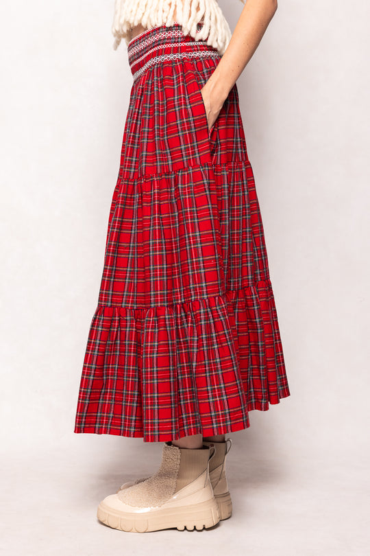 Red plaid skirt worn by a person on a white background