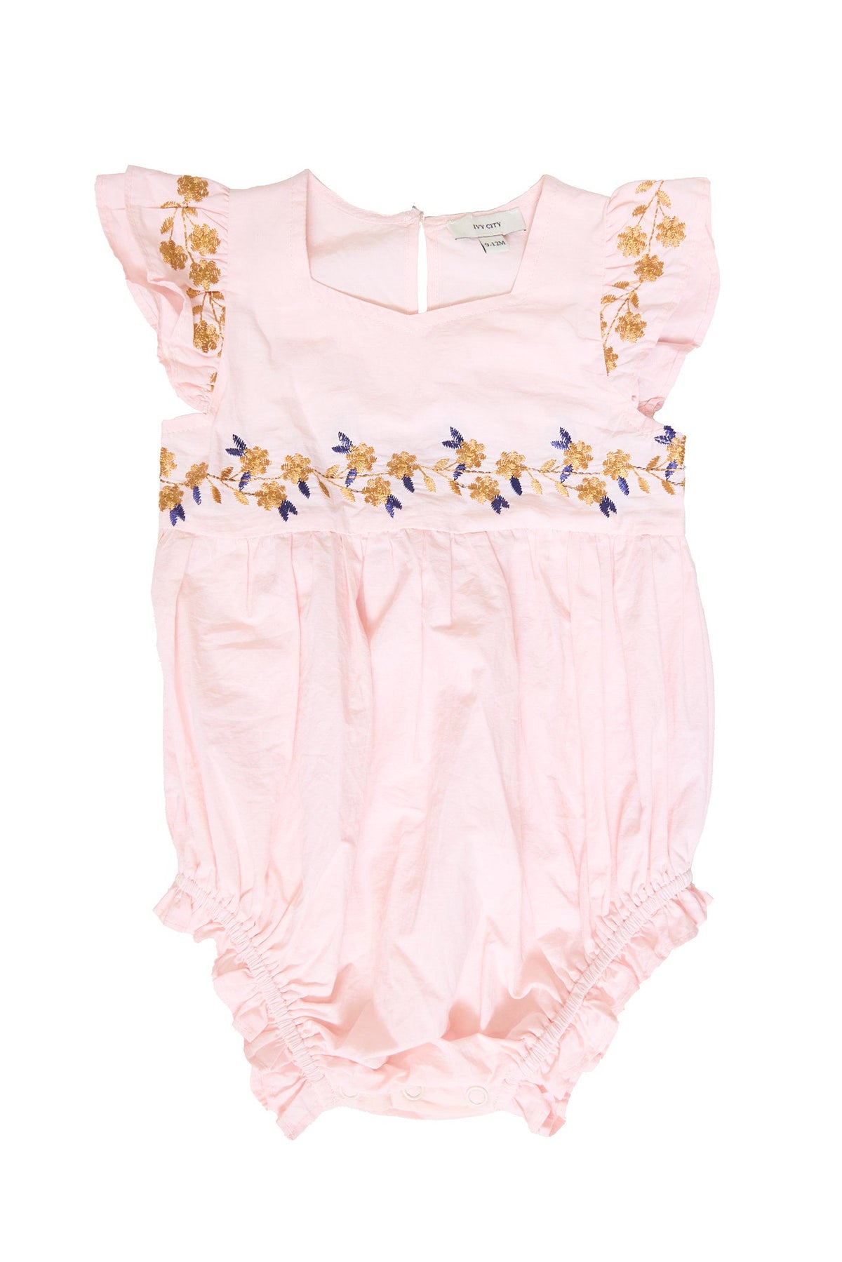 Introducing the Baby Hattie Romper in Embroidered Spring Floral by Ivy City Co—this light pink cotton romper features soft, slightly crinkled fabric for ultimate comfort. Delicate ruffled sleeves and charming yellow and purple spring floral embroidery adorn the chest and upper bodice, making it a stylish choice for your little one.