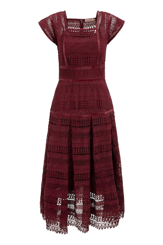 The Amory Dress in Burgundy by Ivy City Co features a square neckline, short sleeves, and a fitted bodice that transitions into a flared skirt. Elegant horizontal lace stripes add texture to the design, while a see-through hem lends a modern touch.