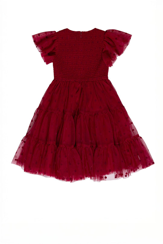 The Ivy City Co Mini Solange Dress in Burgundy Tulle is a girls’ knee-length holiday dress featuring short sleeves, ruffled tulle layers, and a shirred bodice, shown laid flat on a white background.