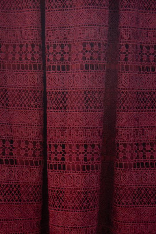 Inspired by the Amory Dress in Burgundy from Ivy City Co, this sheer burgundy lace curtain features intricate geometric and floral patterns arranged in horizontal stripes—echoing the exquisite detailing of the dress. As light gently streams through the fabric, its delicate design is beautifully accentuated.
