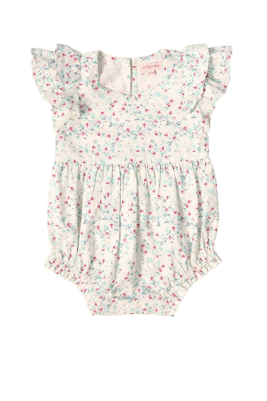 The Baby Hattie Romper in Pansy Trellis by Ivy City Co features short ruffled sleeves, a gathered waist, and a light background decorated with petite pink, blue, and green florals—perfect for creating an adorable Mom & Me Easter look.