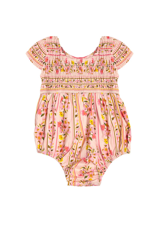 Dress your little one in the Ivy City Co Baby Marlow Romper in Peach Handpainted Flora Stripe, a charming pink smocked baby romper with short sleeves and a delightful floral pattern of yellow and pink flowers with green stems set against a light peach-pink background—a perfect choice for an adorable infant spring outfit.