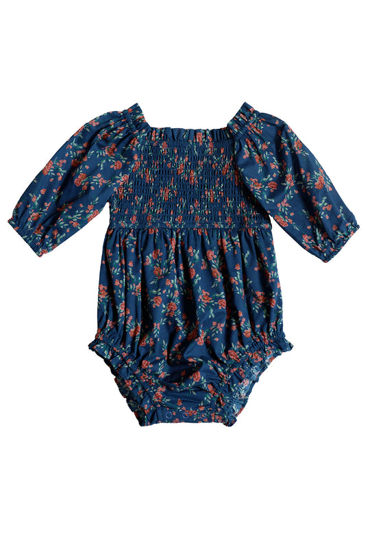 Dress your little one in timeless charm with the Baby Madeline Romper in Midnight Vibrant Chintz by Ivy City Co—a navy blue long-sleeve romper for babies, adorned with a smocked bodice and vibrant red floral pattern, perfect for special occasions.