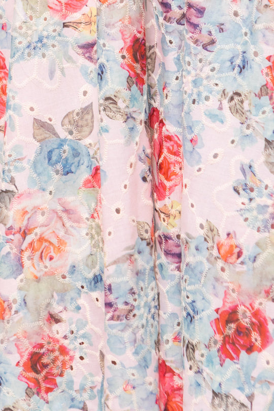 Close-up of the Penny Tank Midi Dress in Multicolor Floral by Ivy City Co, featuring a delicate fabric adorned with pastel pink, blue, and red floral prints. The material is accented with small cotton eyelet cutouts in a repeating pattern on a light, airy background—creating a feminine look that’s perfect for crafting a charming floral dress.