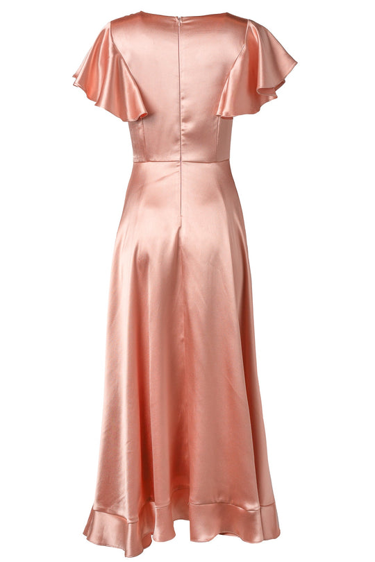 The Callie Dress in Apricot Crush Satin by Ivy City Co features a soft peach-colored satin, flutter sleeves, and a flared, ankle-length hem—shown from the back for an elegant silhouette. Perfect as a bridesmaid dress or for any formal occasion, this gown offers luxurious movement and timeless style.