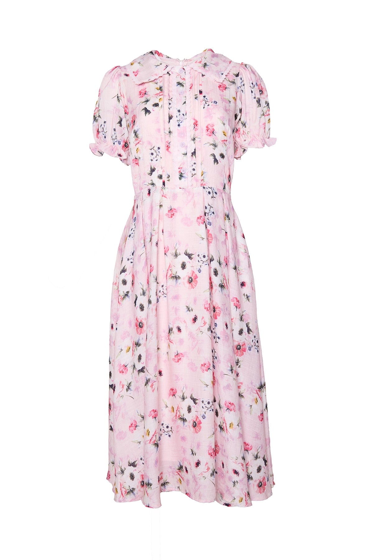 The Sophia Dress in Roselyn Pink by Ivy City Co is a light pink, short-sleeved, mid-length cotton-linen dress featuring a charming floral pattern, puffed sleeves, pleats on the bodice, and a flowy skirt.