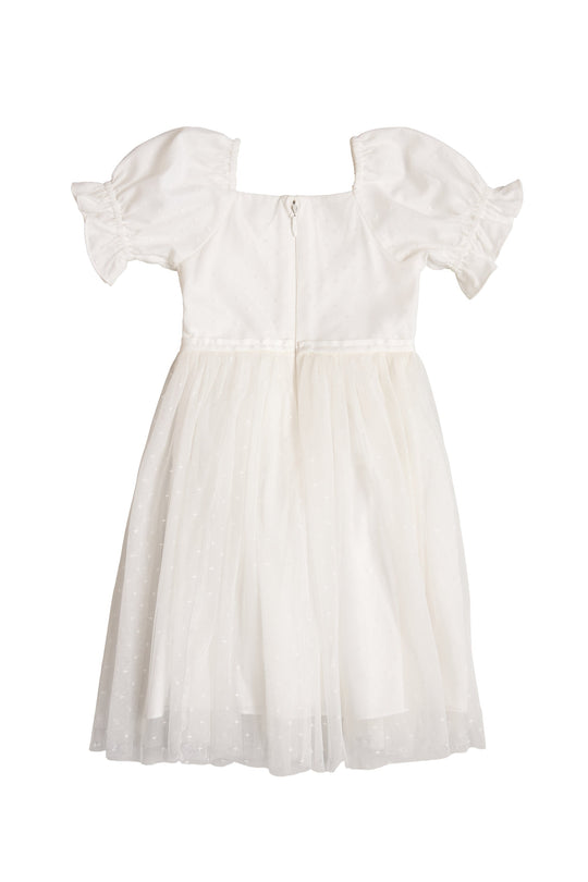 The Mini Ballerina Dress in White by Ivy City Co is a white, knee-length princess dress with short puff sleeves and a tulle skirt, displayed on a white background. This charming dress features a zipper closure at the back.