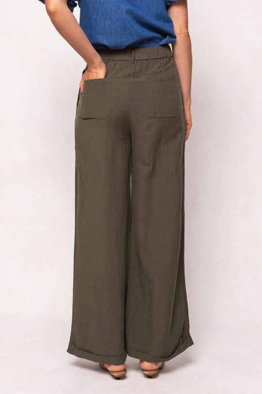 Olive green Ivy City Co Veronica Pants in Green with an elastic waist, back pockets, and cuffed hems, worn with a blue top.
