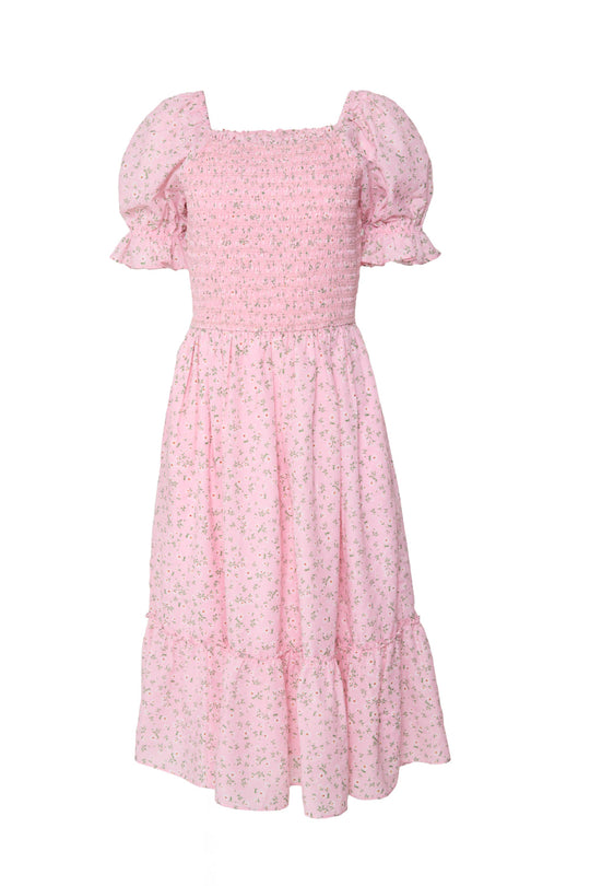 The Valencia Dress in Pink Ditsy Floral by Ivy City Co is a light pink midi dress with puffed short sleeves, a smocked bodice, and a tiered skirt, featuring a charming pink ditsy floral print. Maternity-friendly, this dress effortlessly combines comfort and style for any occasion.