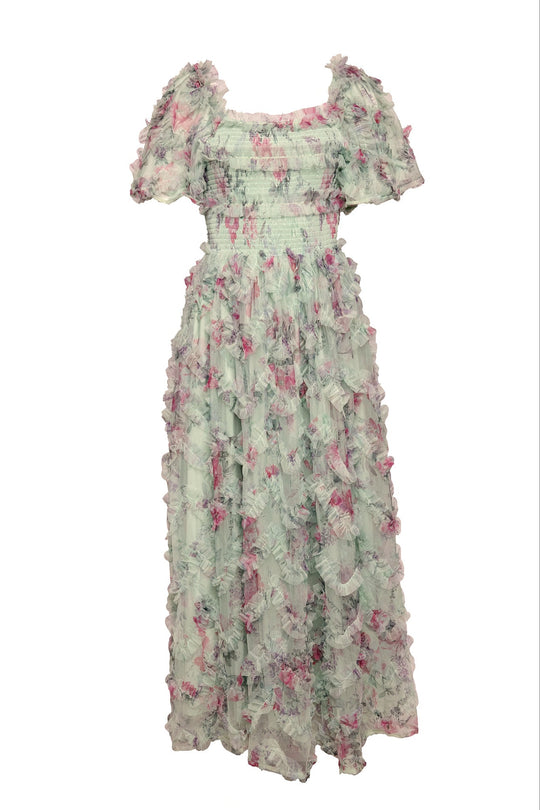 Introducing the Florentina Dress in Pistachio Aquarelle Fleur by Ivy City Co—a pastel green, ankle-length chiffon dress adorned with a delicate pink and purple floral pattern. Featuring short puff sleeves and cascading ruffled layers, this maternity-friendly design combines elegance and comfort for any special occasion.