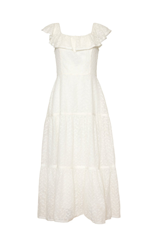 The Alaina Dress in Ivory by Ivy City Co is an ankle-length maxi dress featuring ruffled cap sleeves, a square neckline, and a tiered skirt. Crafted with a subtle textured pattern and designed with a smocked bodice, this dress offers both comfort and style.