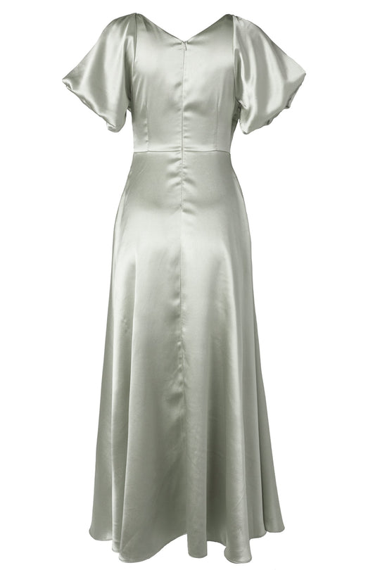 The Tessie Dress in Sage by Ivy City Co features a sage green satin fabric, short flutter sleeves, a fitted waist, and a flared skirt, shown against a plain white background—an elegant option for bridesmaids seeking a modest look or anyone searching for a sophisticated dress for special occasions.