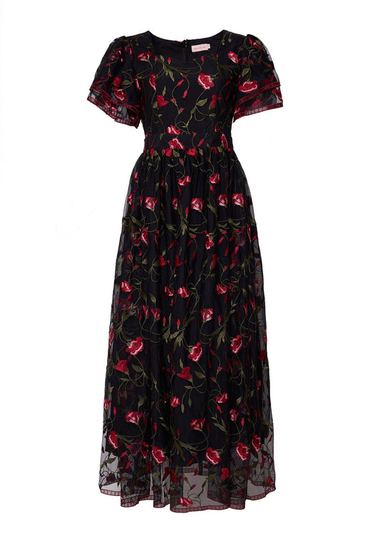 Introducing the Flora Dress in Romantic Roses by Ivy City Co: a black, ankle-length dress adorned with short puff sleeves and an embroidered floral pattern of red roses with green stems. The fitted waist accentuates your silhouette, while a delicate black mesh overlay lends an elegant finishing touch to this enchanting piece.