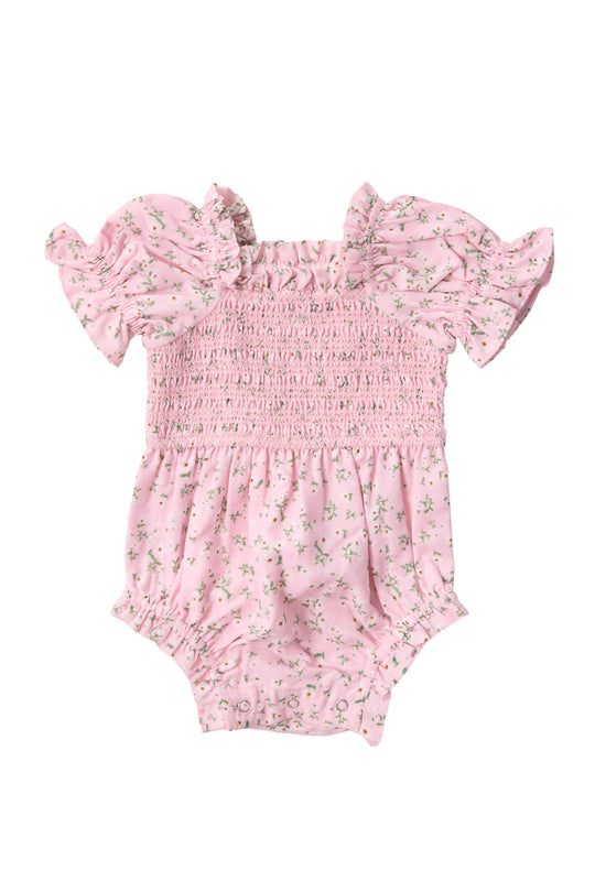 The Baby Valencia Romper in Pink Ditsy Floral by Ivy City Co features a sweet pink ditsy floral print, ruffled sleeves, and a delicately smocked bodice. Designed for both style and convenience, this adorable romper also includes a gathered waist and easy-access snaps at the bottom for quick diaper changes.